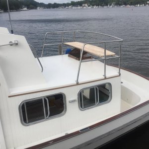 Pilot house new railing (bench seating in progress). We moved the aft ladder to make more room in the aft deck and added steps on port and starboard s