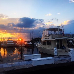 The sun setting on Slow Dance at Southport Marina