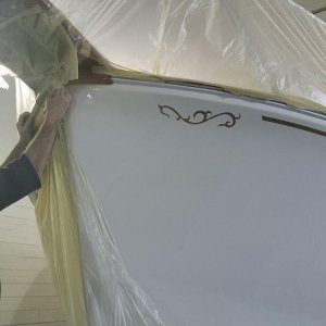 removing tape and plastic after spraying the cove stripe and scroll.
