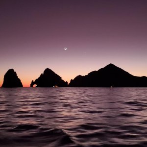 Sunset with crescent moon at Cabo San Lucas.