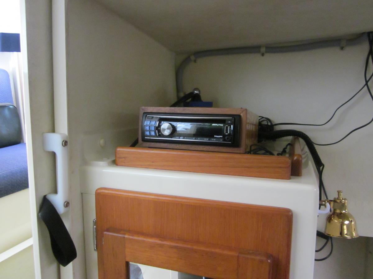 12 volt radio/CD player. That is a home made antenna behind the radio. I listen to a lot of podcast that are played though an IPOD connected to the ra