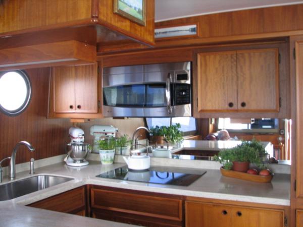 Galley with newer convection/microwave oven and electric cooktop. Under mount SS sink.